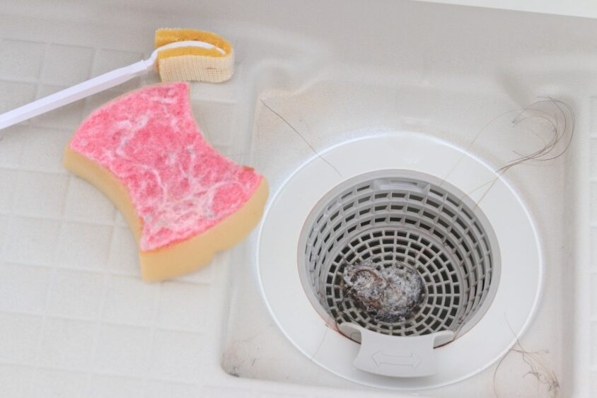 ゴミが溜まったお風呂の排水口とスポンジ